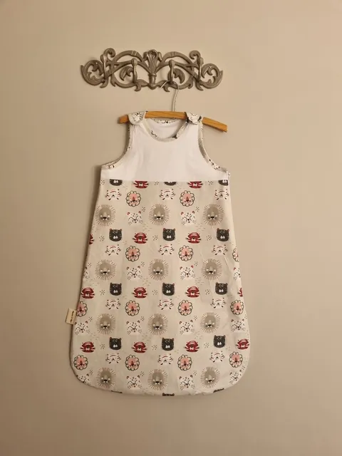 Summer Baby Sleep Sack in the Lions print, hanging on a wall hook